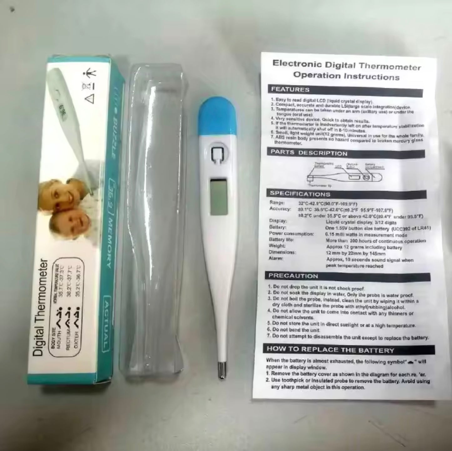 Digital thermometer with packaging and operation instructions on a gray background