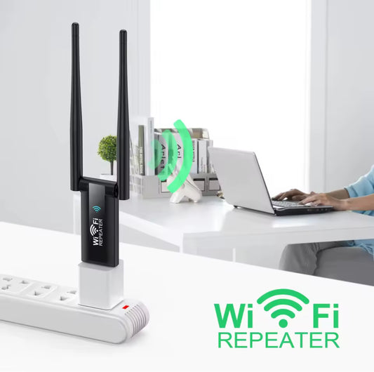 Wi-Fi repeater on a desk with a laptop and books in the background