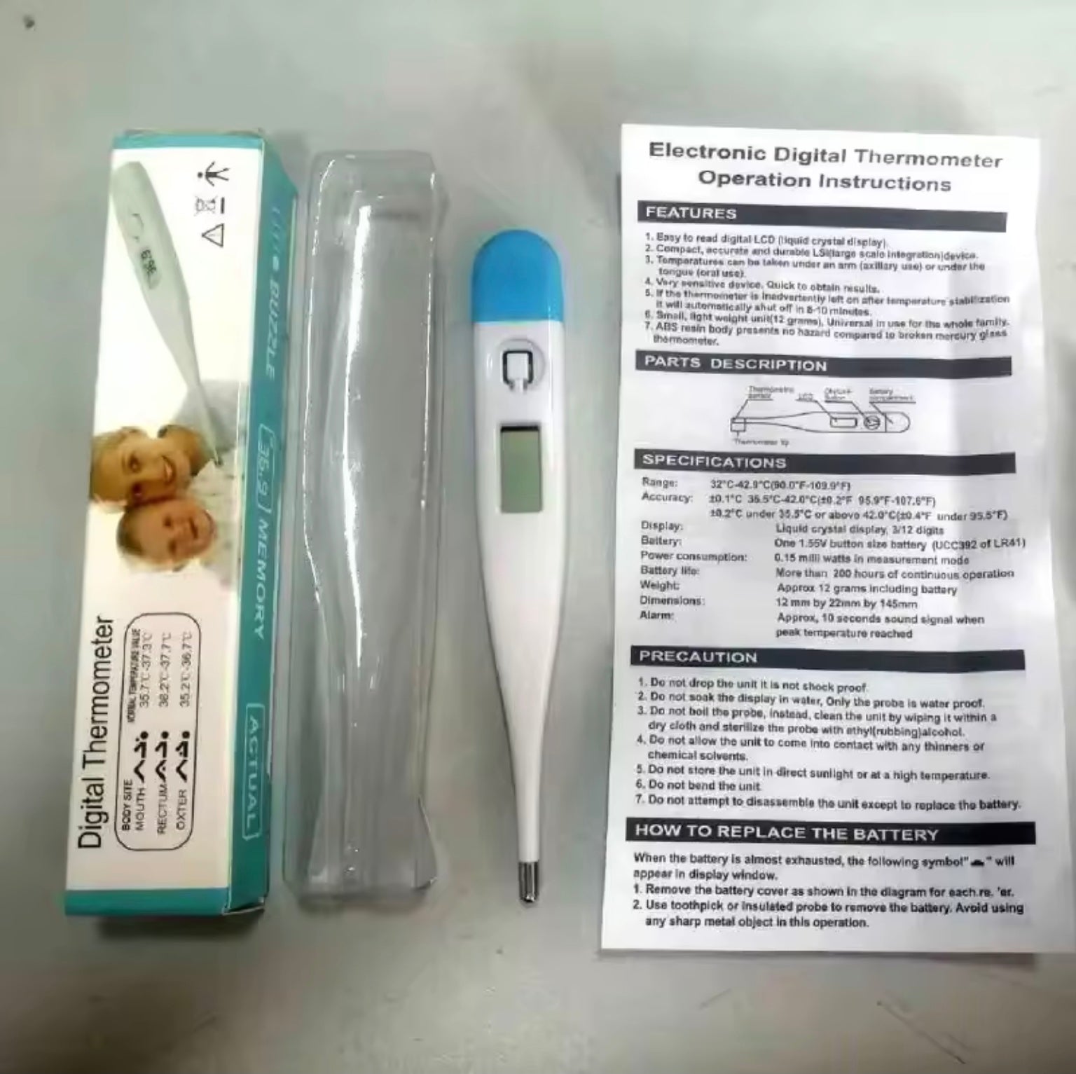 Digital thermometer with packaging and operation instructions on a gray background