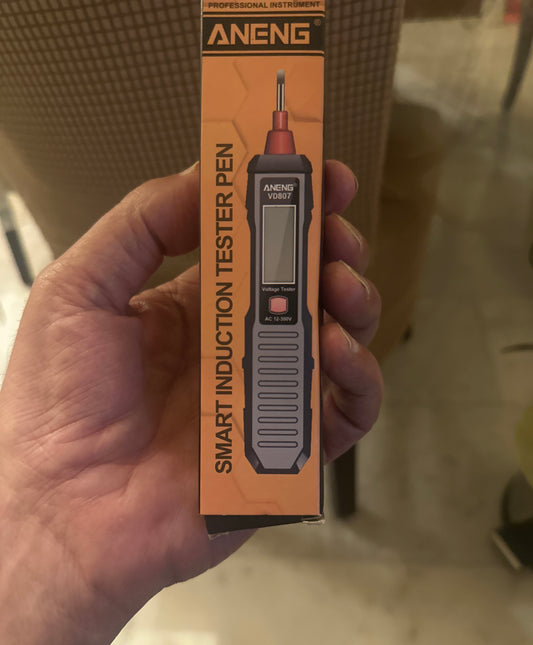 SHIMO/Smart induction tester pen packaging held by a hand with a blurred background